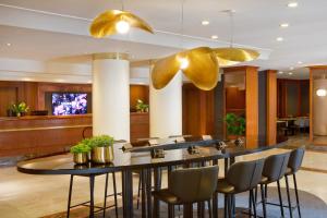 a restaurant with a large table and chairs at Starhotels Tourist in Milan