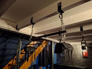 a room with chains hanging from the ceiling at Maison des Soupirs in Montpon-Ménestérol