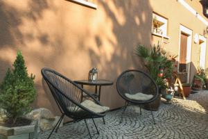 un patio con 2 sedie e un tavolo con piante di Agroturystyka Ulima a Dziwiszów