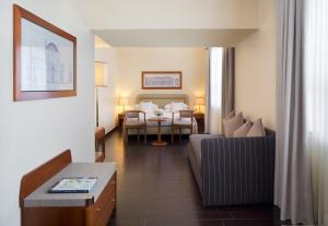 a hotel room with a bed and a living room at Starhotels Business Palace in Milan +59 photos