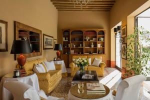 a living room with couches and a table at Villa Michelangelo Vicenza – Starhotels Collezione in Arcugnano