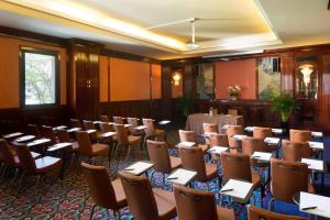 a room full of tables and chairs with notebooks on them at Starhotels Du Parc in Parma