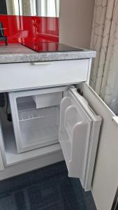 a kitchen counter with an open drawer under a table at HORTENSJA 304 in Koszalin
