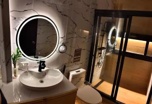 a bathroom with a sink and a mirror at Chapis Transient Home in Baguio +5 photos
