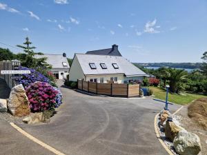 a house with flowers on the side of a road at Atlantik in Loperhet