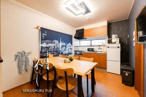 a kitchen with a table and chairs in a room at Senjushuku FUJI 201 北千住 in Tokyo