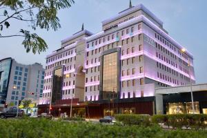 a large white building with purple lights on it at Joudyan Olaya Riyadh By Elaf in Riyadh