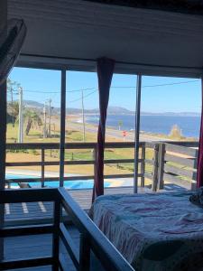a bedroom with a bed and a view of the beach at Mandalas Del Este in Piriápolis +120 photos