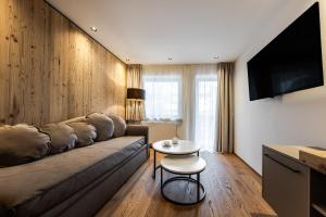 a living room with a couch and a table at Crëp Sella in Colfosco +36 photos
