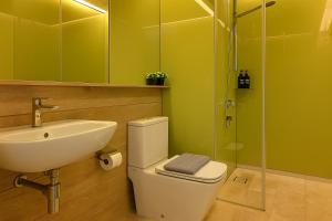 a bathroom with a sink and a toilet and a shower at Sky Suites KLCC - Luxury Service Apartments Near Petronas Twin Tower in Kuala Lumpur +40 photos