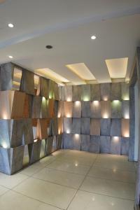 a room with a wall covered in tiles at Hotel King's Heritage in Bareilly