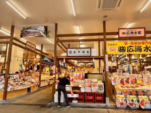 a person standing inside of a grocery store at STAY Akeboshi Kan in Hakodate