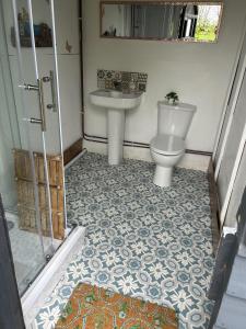 a bathroom with a toilet and a sink at Beautiful Bell Tent Stay in Cowbridge