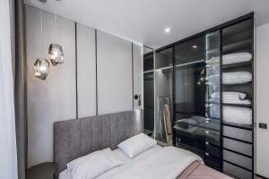 Un dormitorio con una cama y un vestidor. en Petrovdom Apartments 5-123, Building 18, in RC Fayna Town, Saliutna Street 2, en Kiev 10 fotos más