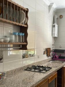 a kitchen counter with a stove and some dishes at Beach Dream in Aouchtame +15 photos