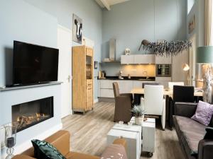 a living room with a couch and a fireplace at Modern Forest Retreat in Bergen in Bergen