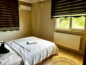 a bedroom with a bed with a remote control on it at MİLA SUİTE in Trabzon +24 photos