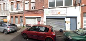a red car is parked on a city street at Capstay - Roubaix - Grande Rue l Netflix - Wifi in Roubaix