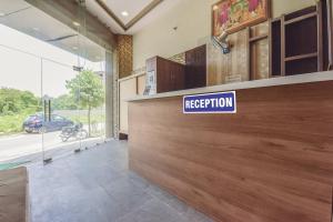 a reception desk in a building with a sign on it at Hotel Shivansh, RIICO Mansarovar in Jaipur