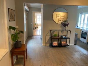 a living room with a table and a mirror at A cosy flat in the heart of Stavanger in Stavanger