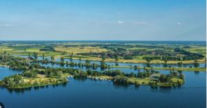 an aerial view of a river with trees and houses at Luxe Suite, Near Station & Free Wifi in Oss +31 photos