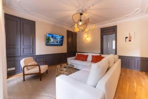a living room with two white couches and a chandelier at Séjour tout confort Emplacement exceptionnel in Rennes