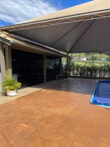 awning over a patio with a swimming pool at Rancho Áustria - Hospedagem Exclusiva in Treze Tílias +27 photos