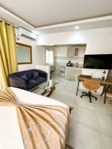 a living room with a bed and a couch and a table at RESIDENCE FABY 1 in Dakar +15 photos