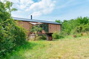 a barn with a grill in front of it at Rosimi Domeček in Valtrovice