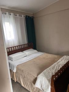 a bedroom with a large bed with a window at LaKour Fleurie Chambres d hôtes in Sainte-Rose