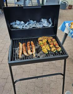 a grill with sausages and other food on it at Atlantik in Loperhet