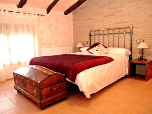 a bedroom with a large bed with a metal headboard at Casa Mairal in Salillas