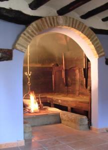 an archway with a fire in a room at Casa Mairal in Salillas