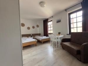 a living room with a couch and a table at Willa BROWAR - Komfortowe Pokoje w Centrum in Starogard Gdański