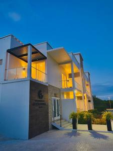 a large white building with its lights on at Cockleshell Villas in Basse Terre Town
