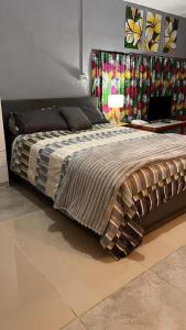 a bedroom with a large bed and a table with a laptop at Studio House Close to Shore 