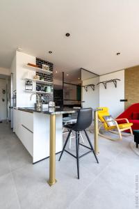 a kitchen with a table and chairs in a room at Ecstatic Living Ixelles, Luxury in the European Quarter in Brussels