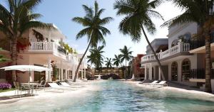 a swimming pool in front of a building with palm trees at Luxury resort in Jericoacoara