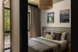 a bedroom with a bed and a window at WIDOQ Resort Szczyrk in Szczyrk