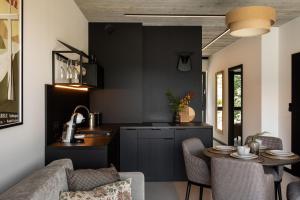 a kitchen with a table and a kitchen with a counter at WIDOQ Resort Szczyrk in Szczyrk