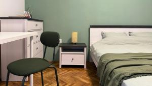 a bedroom with a bed and a desk and a chair at Apartment Burin in Viskovići