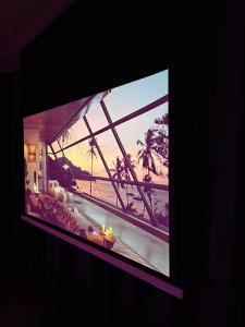 a television screen with a picture of a beach at Love Room 85 in Kortrijk