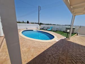 a pool on the roof of a house at Marmario Villa 10 in Anarita