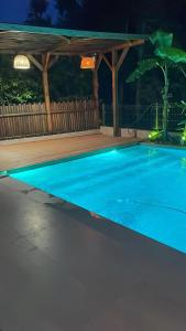 a swimming pool in a backyard at night at Escape by Form Villa Olea 3 with pool in Dhërmi
