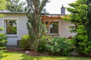 a house with trees and bushes in front of it at Holiday Homes Puck Garden Estate in Puck