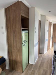 a kitchen with a green refrigerator in a room at Severn valley caravan park in Quatford
