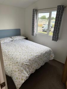 a bedroom with a bed and a window at Severn valley caravan park in Quatford