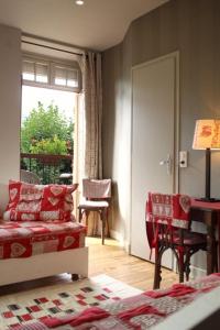 a living room with a couch and a table and a window at Villa Bon Repos in Argelès-Gazost