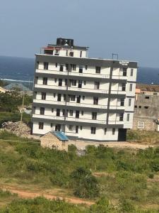 a large white building on top of a hill at N&G Blessed Pioneer Holiday Homes in Mombasa