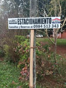 a street sign on top of a wooden pole at Familia Cabrera Rojas in Nueva Alborada